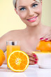Beautiful woman making orange juice