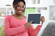 Photo: Cheerful woman showing digital tablet Cheerful woman showing digital tablet