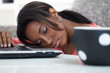 Photo: Young women sleeping with her head on a laptop Young women sleeping with her head on a laptop