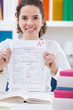 Teenager girl  holding test paper with result