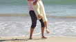 Close Up Of Senior Man Picking Up Senior Woman At Waters Edge