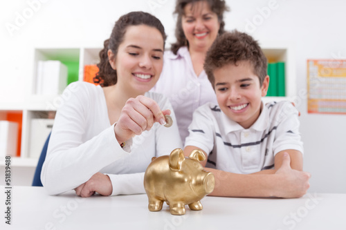 Photo: Happy family with piggybank Happy family with piggybank