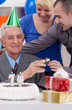 Photo: Senior man with children on birthday Senior man with children on birthday