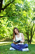 Young woman in green park, book and reading