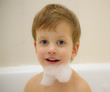 The boy with a beard from foam in a bathroom