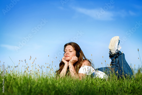 Photo: Young girl relaxing and listening music Young girl relaxing and listening music