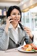 Photo: Young businesswomen eating in restaurant Young businesswomen eating in restaurant