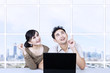 Asian couple looking up in office