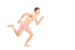 An embarrassed naked man in underwear running away