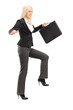 Businesswoman holding a briefcase and trying to keep balance