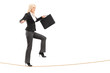Businesswoman with briefcase, trying to keep balance while walki