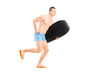 Full length portrait of a male surfer holding a surfboard and ru