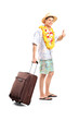 Smiling man carrying his luggage and giving thumb up