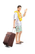 Smiling man carrying his luggage and waving goodbye