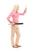Full length portrait of a violent young woman holding a baseball