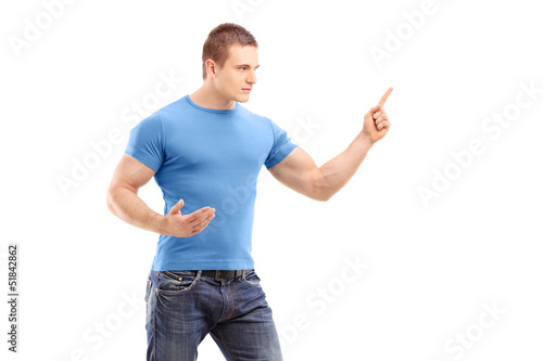 Photo: An anger young man pointing with finger and threatening An anger young man pointing with finger and threatening