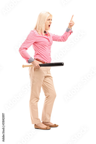 Photo: Full length portrait of a violent young woman holding a baseball Full length portrait of a violent young woman holding a baseball