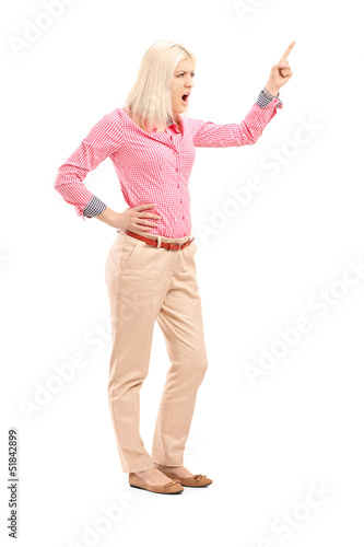 Photo: Violent young woman shouting and pointing with finger Violent young woman shouting and pointing with finger