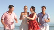 Video: Group Of Friends Running Up Beach Towards Camera Group Of Friends Running Up Beach Towards Camera