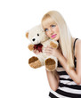 Beautiful blonde girl wearing pajamas with teddy bear