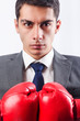 Young businessman with boxing gloves