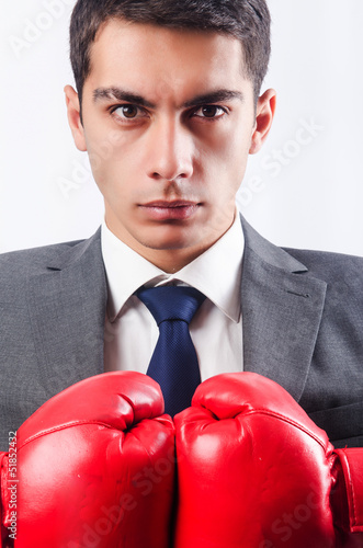 Photo: Young businessman with boxing gloves Young businessman with boxing gloves