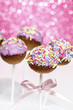 Pink cake pops decorated with colorful sprinkles
