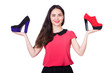 Young woman with choice of shoes on white