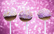 Pink cake pops decorated with colorful sprinkles