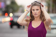 Woman removing her glasses
