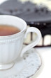 cup of tea and cake with chocolate icing