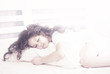 beautiful little girl sleeping on a pillow in bed