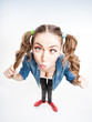cute funny girl with two pony tails cross looking - wide angle