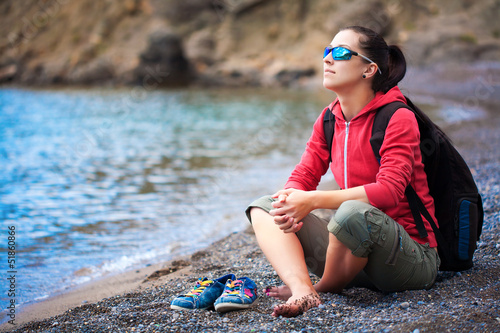 Photo: pretty woman is resting on the beach pretty woman is resting on the beach
