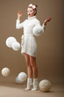 Falling Skeins. Woman in Knitted Jersey. White Balls of Yarn