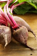 fresh organic beets with leaves on a wooden background