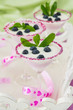 Photo: Fresh blueberry yogurt dessert in martini glasses and leafs of m Fresh blueberry yogurt dessert in martini glasses and leafs of m