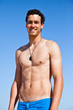 Handsome fit young man wearing a blue bathing suit