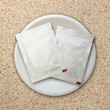 Photo: silver package on white plate silver package on white plate