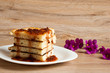 A stack of pancakes with jam gooseberry