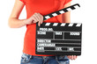 Movie production clapper board in hands isolated on white