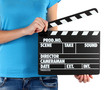 Movie production clapper board in hands isolated on white