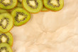 Kiwi slices frame on color background