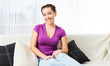 Foto: Girl sitting on a sofa Girl sitting on a sofa