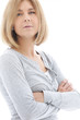 Thoughtful woman standing with folded arms