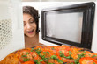 Girl open a microwave