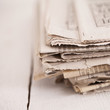 Pile of newspapers on a white table
