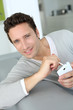 Man relaxing in sofa and reading his emails