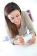 Young woman using smartphone at home
