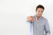 Adult man pointing at camera on white background